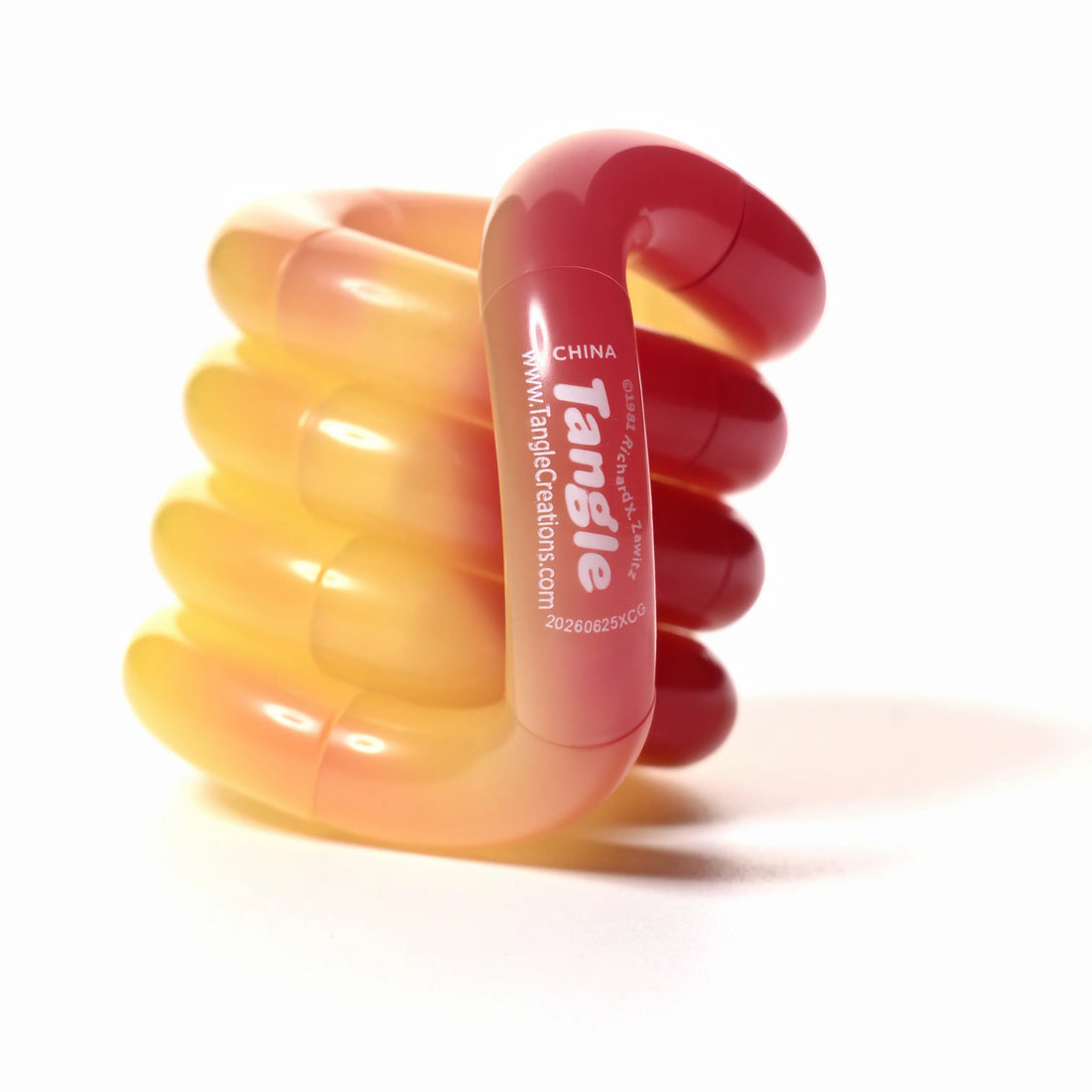 Tangle® Jr Bubblegum orange et rose translucide, fidget à manipuler