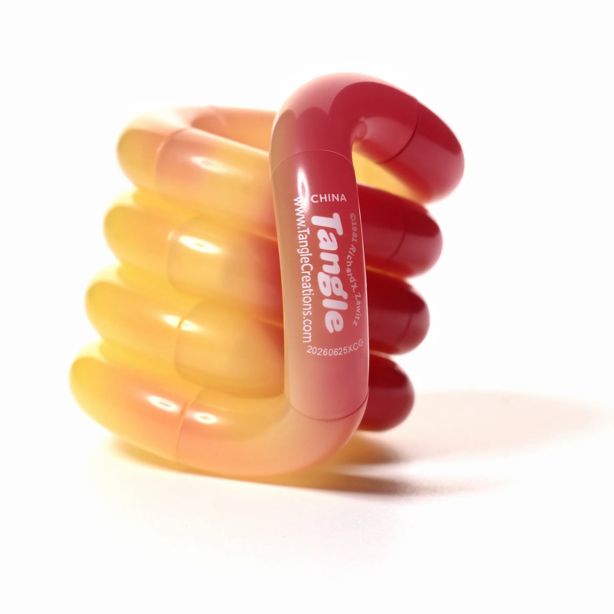 Tangle® Jr Bubblegum orange et rose translucide, fidget à manipuler