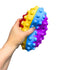 Main appuyant sur une bulle de la balle de rugby Pop It multicolore