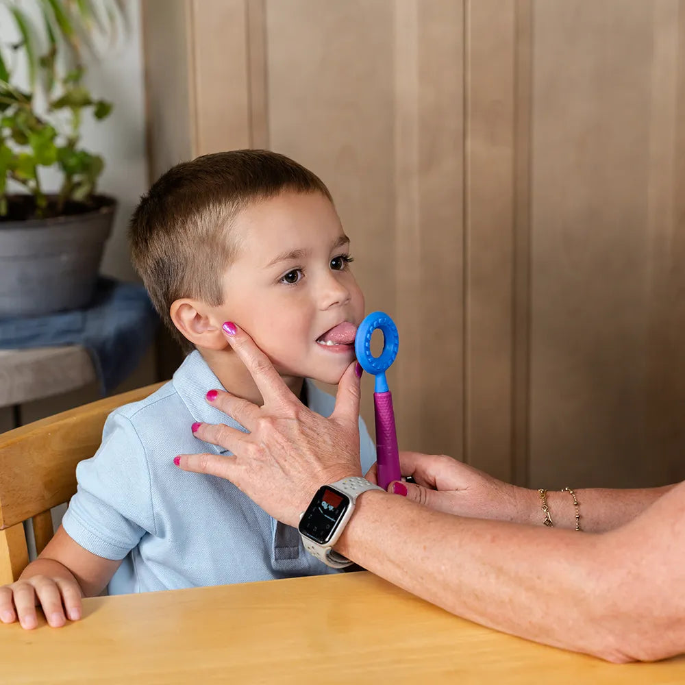 Utilisation de l’embout rond bleu ARK sur un Z‑Vibe pour stimuler la langue et la motricité orale chez un enfant.