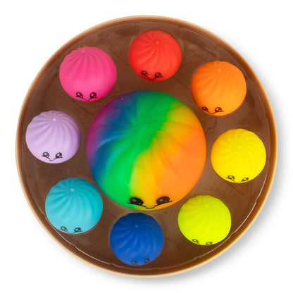 Panier vapeur vu du dessus avec un grand squishy arc-en-ciel et huit petits squishies colorés